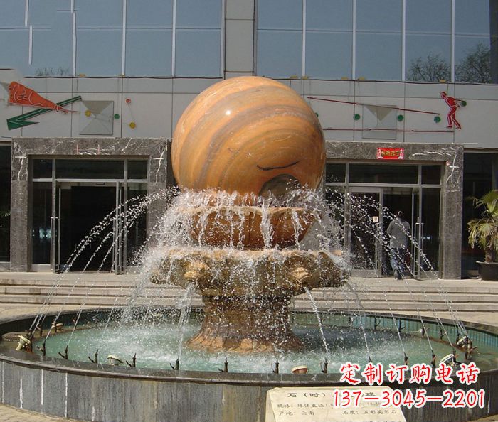 大连石来运转球晚霞红风水球石雕